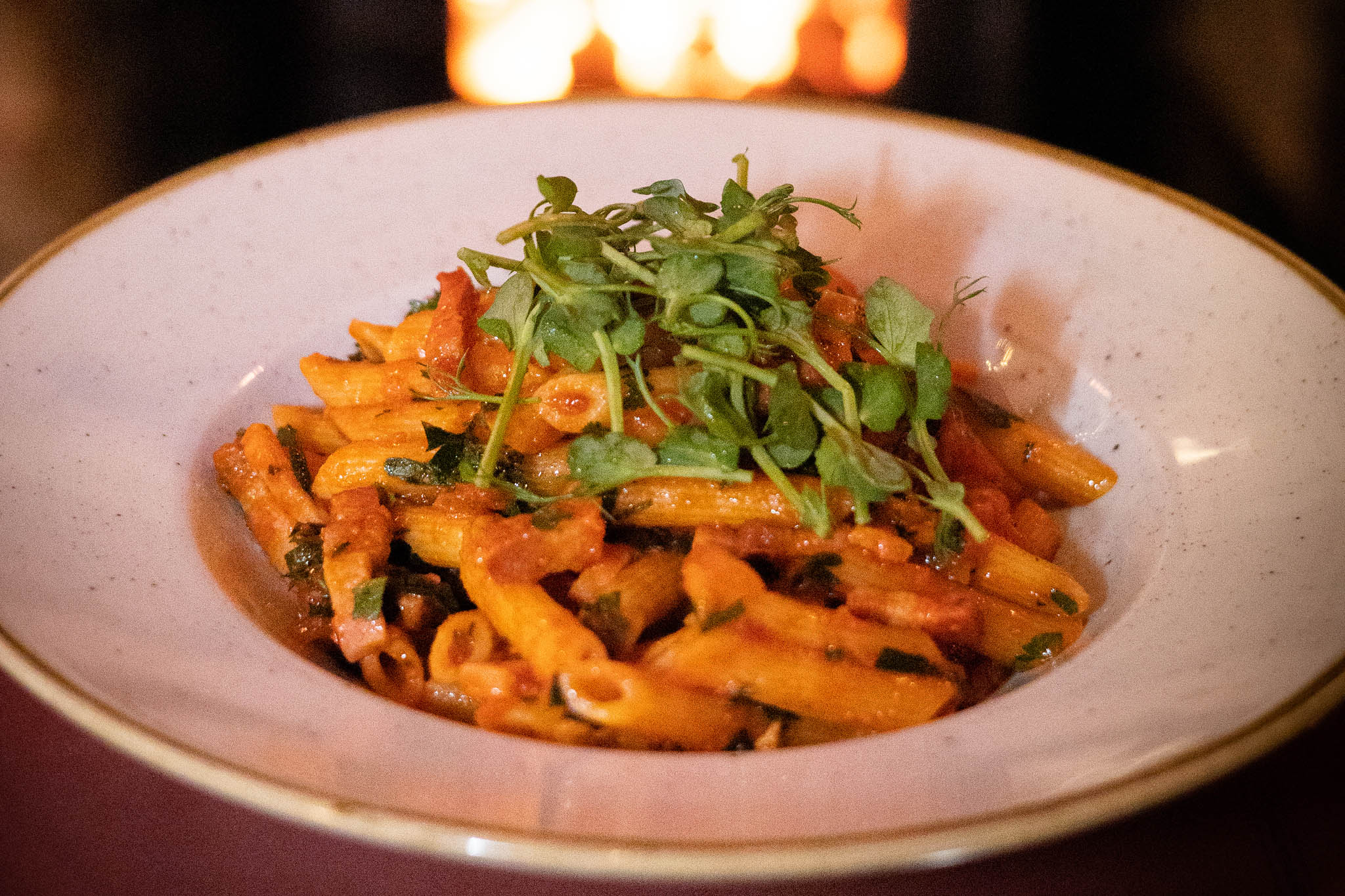 A beautiful traditional pasta dish served with a topping of fresh cress